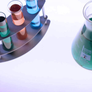 Beakers and tubes with different color liquids in them on a table