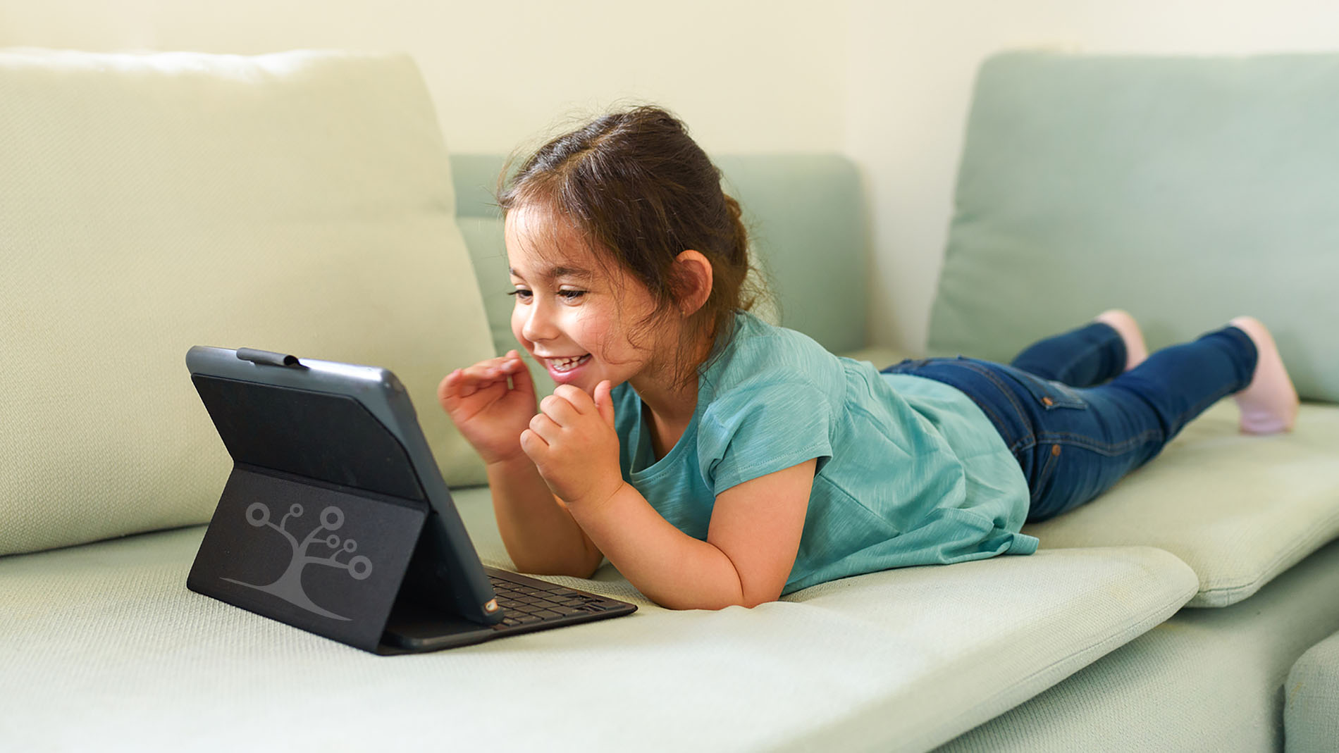 Happy little girl is studying connected in streaming with the teacher online.