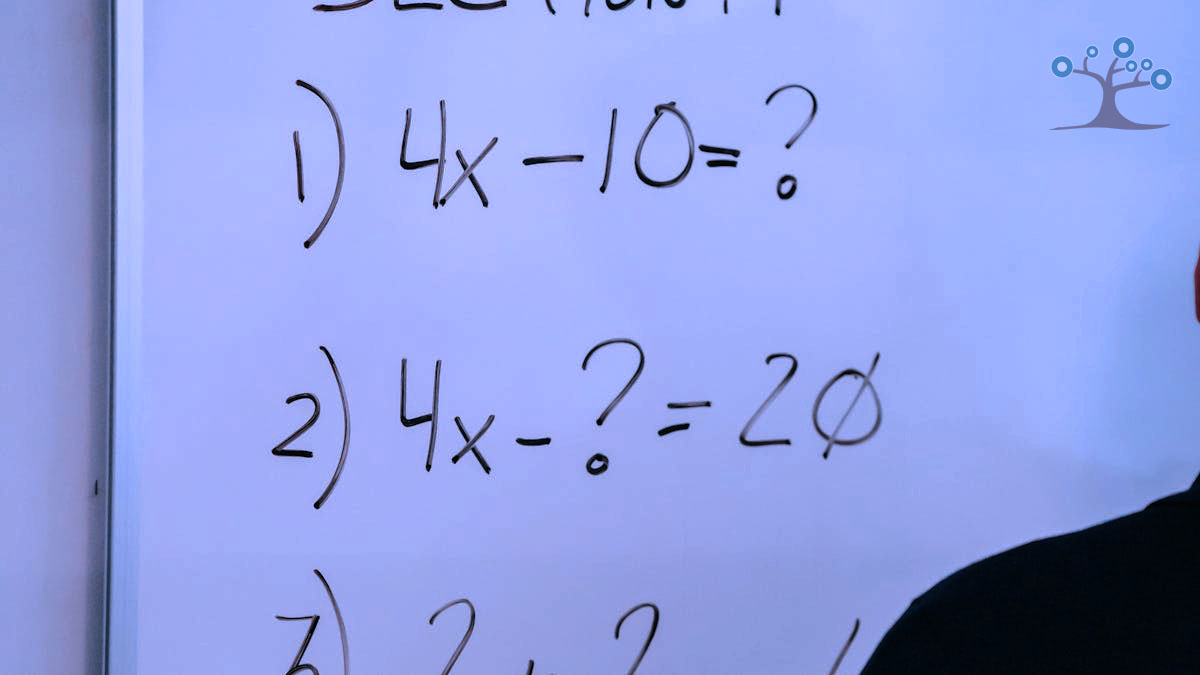 A whiteboard with algebra problems on it.