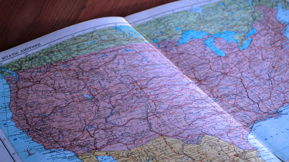 An atlas open to a map of the United States
