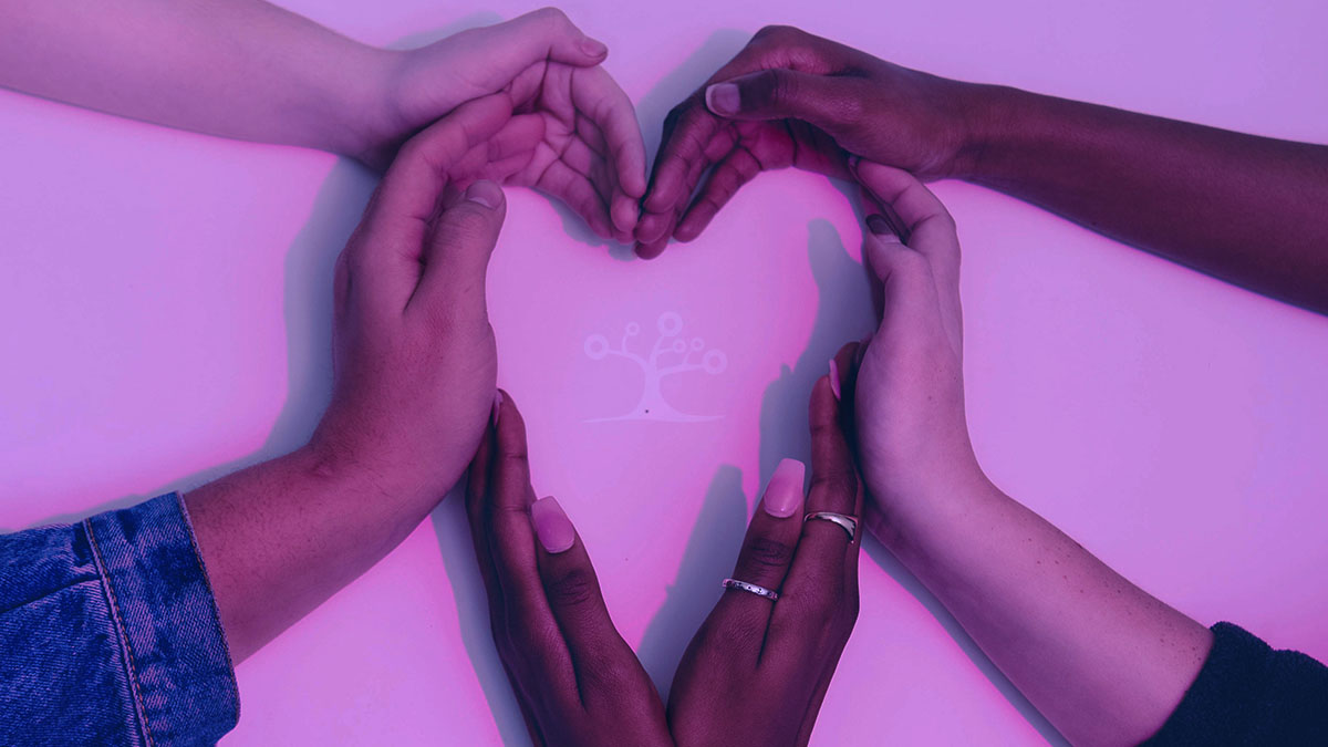 Hands with different skin tones forming the shape of a heart.